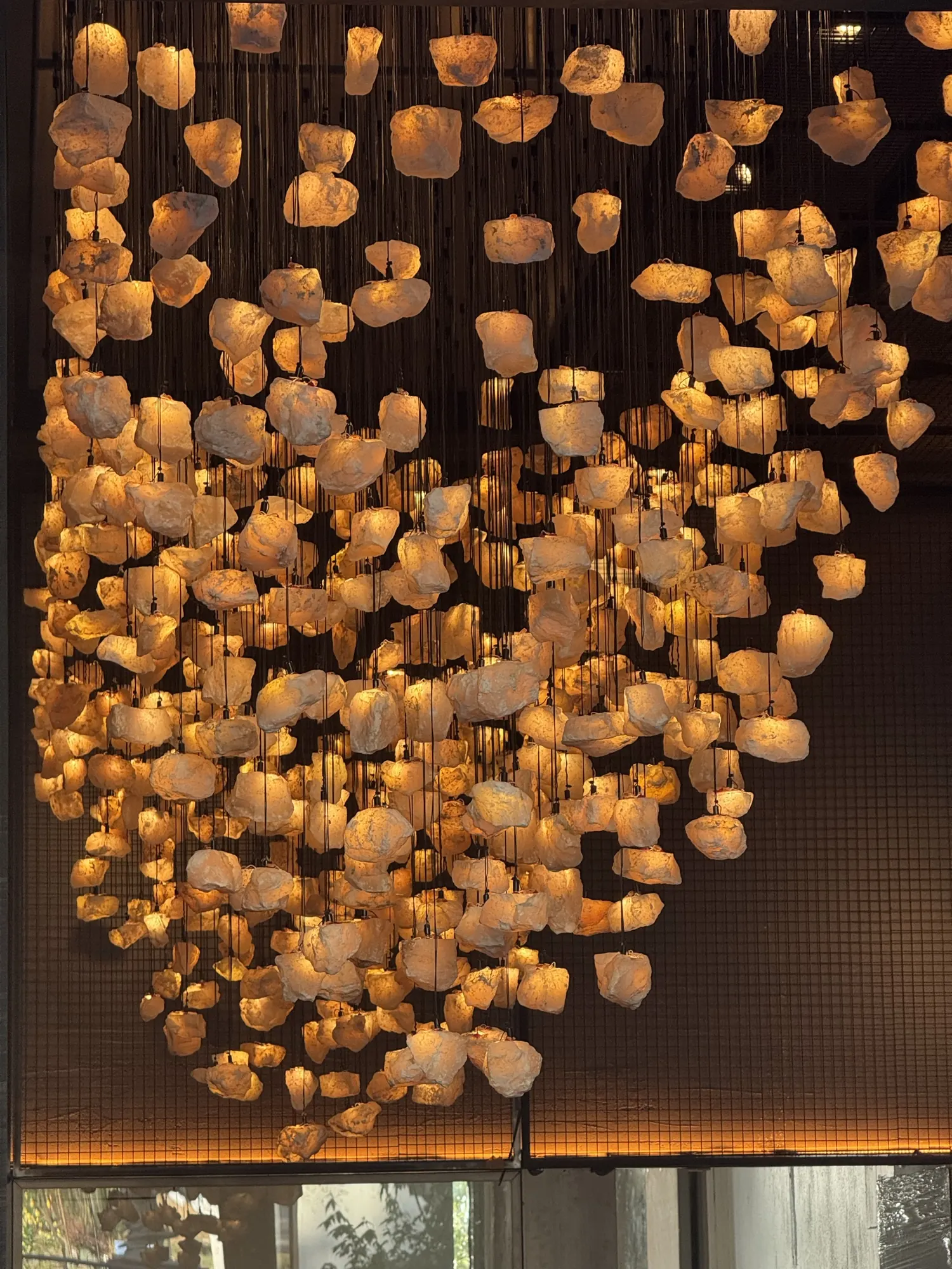 Close view of the glowing pink onyx pieces hanging from the ceiling